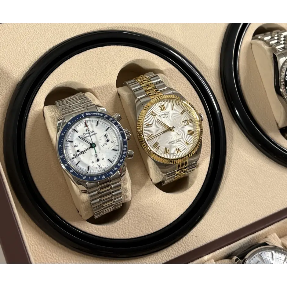 Close-up of two watches on the winder cups of the brown Kensington