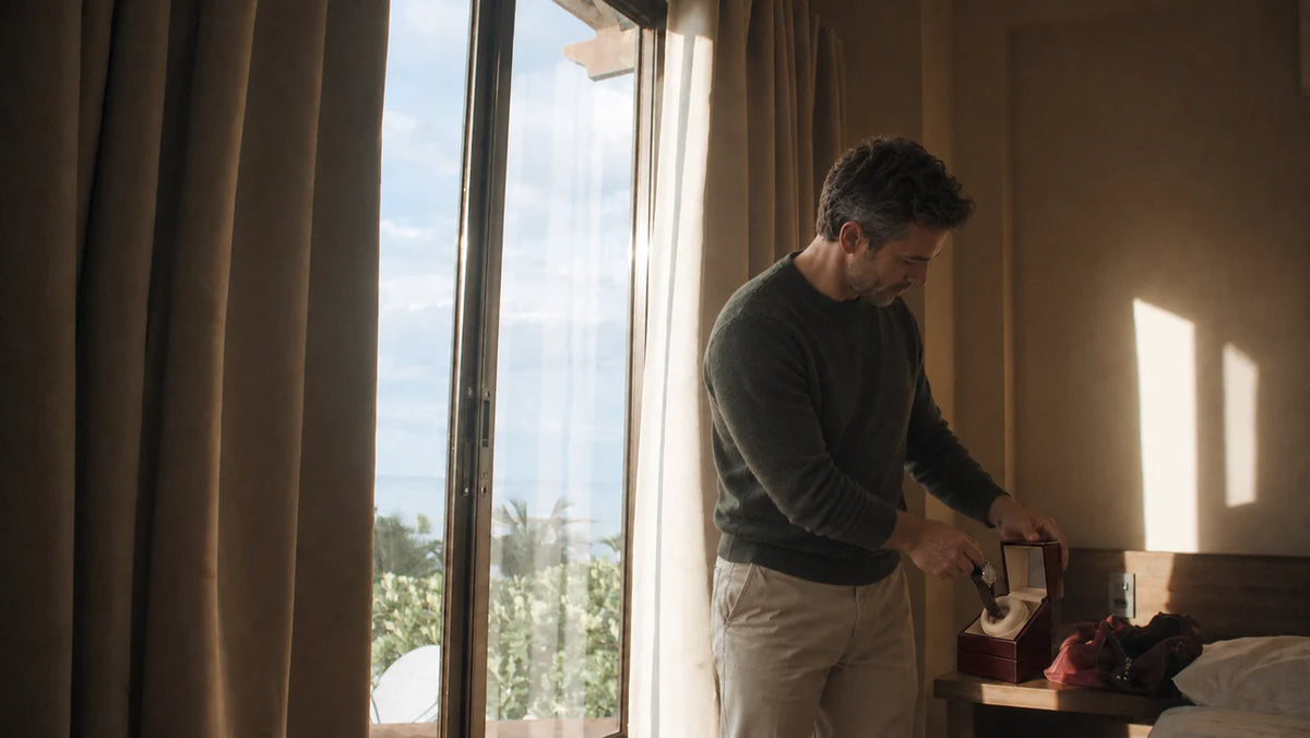 A man placing his watch in an Ashford winder at home